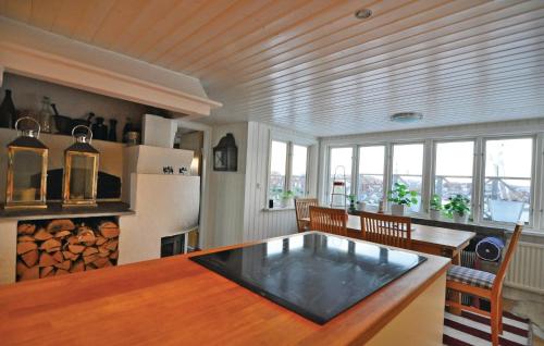 a dining room with a table and some windows at 2 Bedroom Stunning Home In Rönnäng in Rönnäng