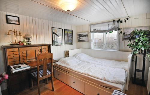 a bedroom with a bed and a table and a desk at 2 Bedroom Stunning Home In Rönnäng in Rönnäng