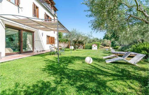 a yard with a house with a table and chairs at Villa Luca in Vitorchiano
