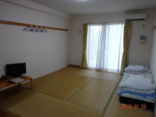 Ein Bett oder Betten in einem Zimmer der Unterkunft Minshuku Getto