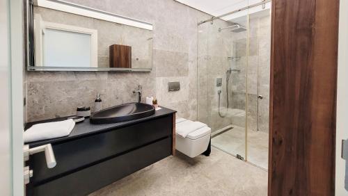a bathroom with a sink and a shower at Villa Çimentepe in Bodrum City