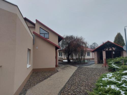 a house with a driveway next to a building at Penzion TOŠA in Klášterec nad Ohří