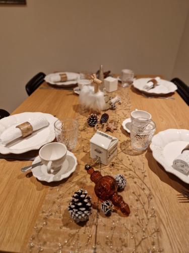 a wooden table with christmas decorations on it at La Mara Élo in Sart-lez-Spa