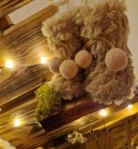 a stuffed animal hanging from a ceiling with lights at La Mara Élo in Sart-lez-Spa
