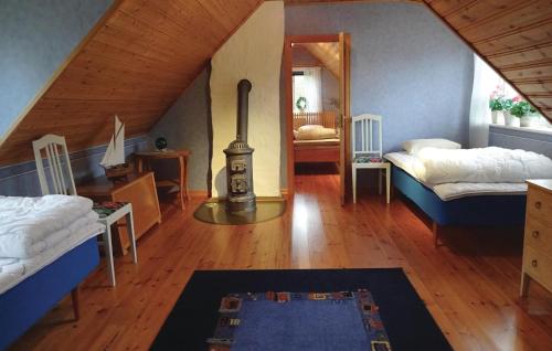 a attic room with two beds and a mirror at Lovely Home In Sölvesborg With Wifi in Hällevik