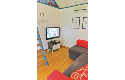 a living room with a couch and a tv at Beautiful Home In Färjestaden With Wifi in Färjestaden