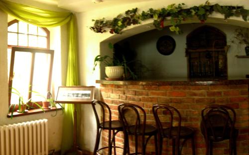 a room with chairs and a brick fireplace at Pensjonat Eldorado in Świeradów-Zdrój