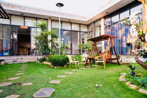 a garden with a playground and a swing at The Stay Villa Pleiku in Pleiku