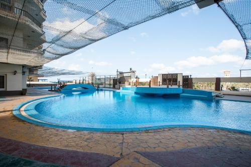 a large swimming pool on top of a building at AIFU Hotel El Montazah Alexandria in Alexandria