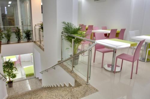 a dining room with pink chairs and a table at Christina Hotel in Bucharest
