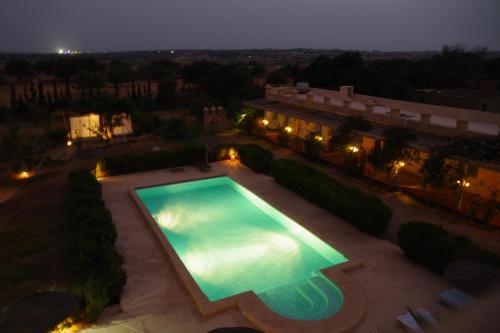 an overhead view of a swimming pool at night at Artgana Lodge in Essaouira