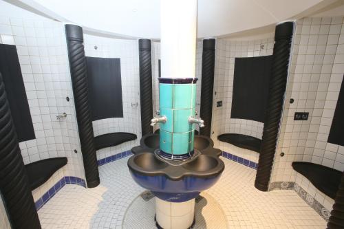 a bathroom with a toilet in a stall at 25h SPA-Residenz BEST SLEEP privat Garden & POOLs in Neusiedl am See