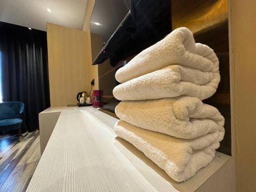 a pile of towels sitting on a counter in a room at Hotel Hardik Palacio in Varanasi