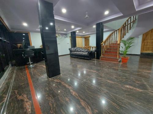 a living room with a lobby with a couch and stairs at PRIVATE HOME STAY in Secunderabad