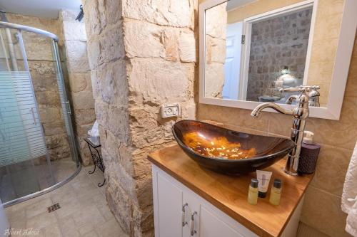 a bathroom with a sink and a shower at The Antiquity Heart Mansion in Safed