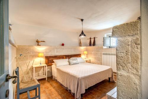 a bedroom with a bed in a room at Country House da Già in Ostuni