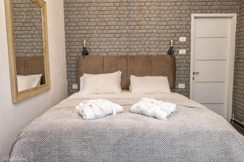 a bedroom with a bed with two pillows on it at The Antiquity Heart Mansion in Safed