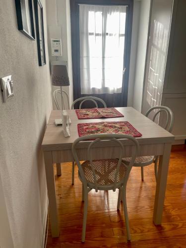 a dining room table with chairs and a table and a table and chairsktop at Casa Al Bottalino in Biella