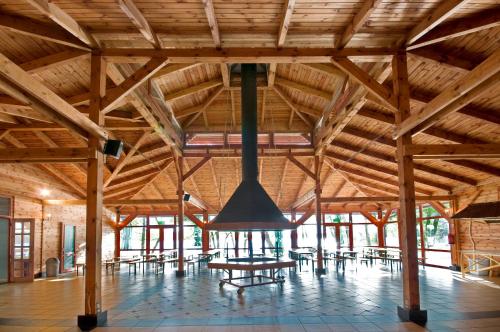 a large room with a table and chairs in a building at Hotel Szarlota - Kompleksowo na Kaszubach in Kościerzyna