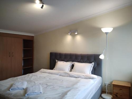 a bedroom with a large bed with white sheets and pillows at Ośrodek Wypoczynkowy Zapalenica in Szczyrk