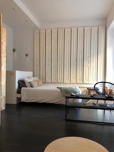 a bedroom with a large bed and a table at Balcón del Puerto Luxury Suite - VUT-3921-AS in Gijón