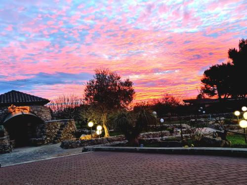 a sunset in a park with a red sky at Hotel Villa Elisabetta in Galatina