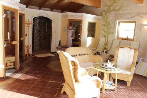 a living room with wicker chairs and a table at Haus Anni in Radstadt