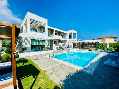 a villa with a swimming pool and a house at Aelia Living in Stavros