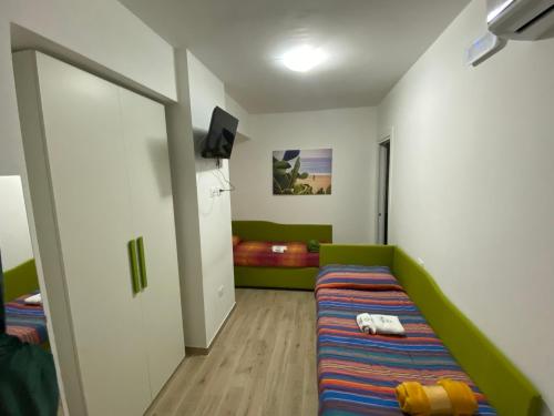 a small room with a bed and a bedroom with at Dimora Leone in Diamante