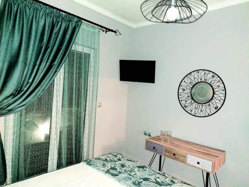 a bedroom with a bed and a window with a mirror at Art and view-studio in Kounoupidhianá