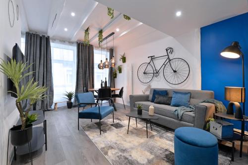 a living room with a couch and a bike on the wall at Les suites du centre historique in Colmar