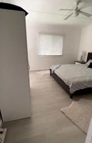 a bedroom with a bed and a ceiling fan at Shoal Bay Serenity Beach Cottage Newly Renovated in Shoal Bay