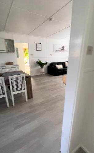 a kitchen and living room with a table and chairs at Shoal Bay Serenity Beach Cottage Newly Renovated in Shoal Bay