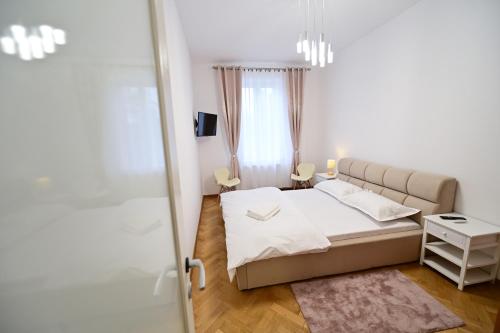 a small bedroom with a bed and a window at FLH - Kaly's Place in Sibiu