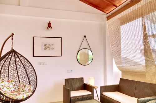 a living room with a swing and a chair at Island Ambience in Maafushi