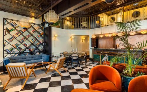 a lobby with a couch and chairs and a table at Villa Brown Tel-Aviv, a member of Brown Hotels in Tel Aviv