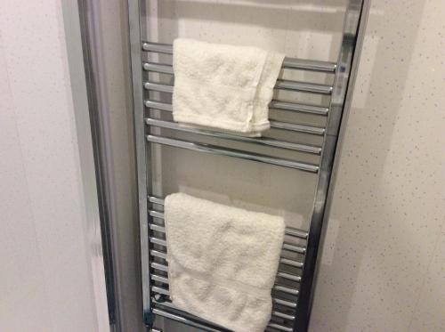 a towel rack in a refrigerator with white towels at 103 Nelson Street Ground Right Largs in Largs