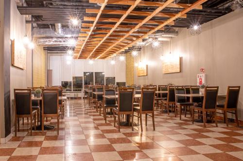 a large room with tables and chairs in it at Rija Bauska Hotel in Bauska