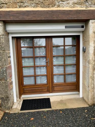 a wooden door with glass windows in a building at Le paradis des oiseaux in Saint-Gildas