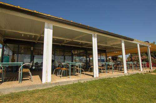 a building with tables and chairs in it at Iate Glória Sem-fim Monsaraz in Monsaraz