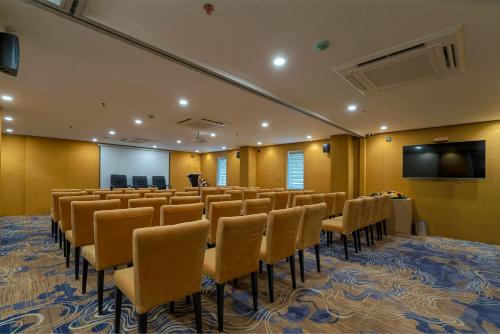 a conference room with chairs and a flat screen tv at THE PORT BY JDANIELS in Trivandrum