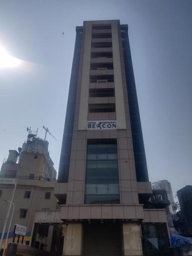 a tall building with a sign on it at Adiva Residency Beacon, Grant Road, Mumbai in Mumbai