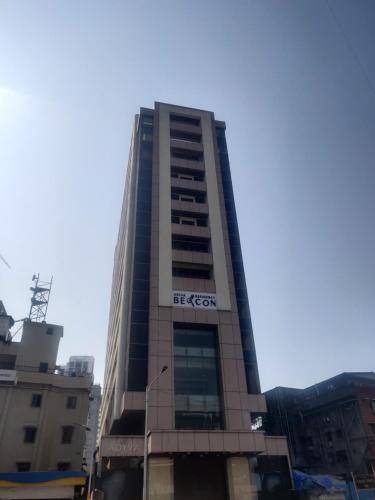 a tall building with a sign on it at Adiva Residency Beacon, Grant Road, Mumbai in Mumbai