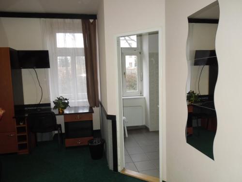 a hallway with a room with a desk and a mirror at Masarykova Kolej in Prague