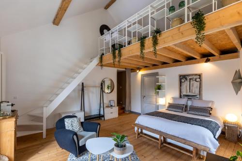 a bedroom with a bed and a loft at La Burie in Saint-Savinien