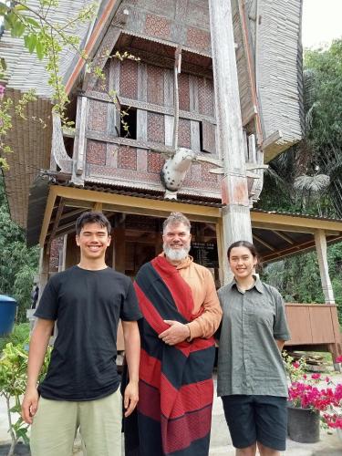 a group of people standing in front of a house at NUANSA HOMESTAY Authentic&Hospitality in Rantepao