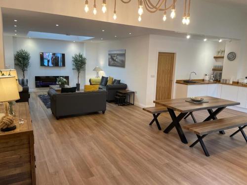 a living room with a couch and a table at Redstones Cottage in Greasby