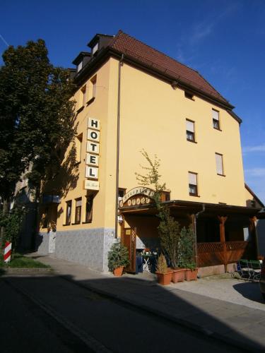a large yellow building with a sign on it at Hotel La Ferté in Stuttgart