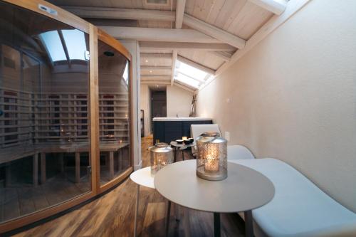 a room with two tables and a wine cellar at Masseria Messapia Wine Resort & Spa Salento in Mesagne