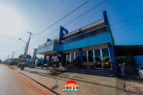 a blue building on the side of a street at Hotel Borari in Alter do Chao